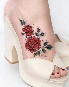 a woman's foot with a rose tattoo on the side of her shoe,