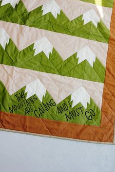 an orange and green quilt with words written on it