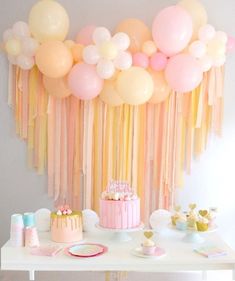 a party with balloons, cake and decorations