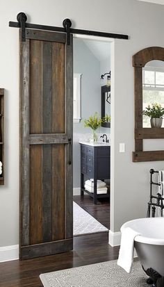 a bath room with a tub and a wooden door