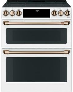 two white and gold ovens side by side