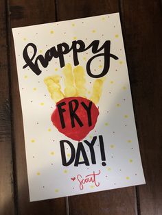 a sign that says happy fry day hanging on a wall with a handprinted image