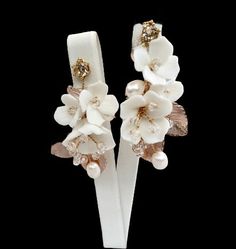 Elegant and romantic, this exquisite pair of earrings is a trendy accessory for your Special Day. Adorned with a combination of delicate ceramic flowers and glowing crystals on a silver/gold base, it will add an extra touch of glam to finish off your perfect look on your perfect day. Length - 2.1" (approx. 5.4cm); Width - 1.2" (approx. 3cm); Weight - 3.6g. Cast in lightweight alloy and silver / gold plated for a flawless finish, the earrings are hypoallergenic - lead, nickel and cadmium free. Av Elegant Rose Gold Flower Clip-on Earrings, Delicate White Crystal Earrings For Party, Elegant Gold Jewelry With 3d Flowers, Elegant White Crystal Earrings For Gift, White Flower Earrings For Evening, Elegant Party Earrings With 3d Flowers, Elegant Handmade Flower Drop Bridal Earrings, Elegant Dangle Bridal Earrings With 3d Flowers, Elegant Bridal Flower Earrings With Handmade Flowers