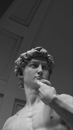 black and white photograph of a statue of a man with his hand on his chin