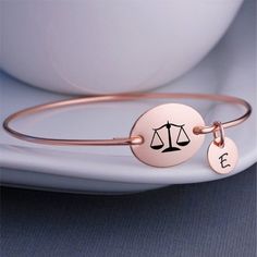 Each bangle is hand formed from heavy gauge wire and then hammered for shine and strength. An oval measuring 3/4 inch across is engraved with the scales of justice. **ALL charms are optional. Choose the number of charms you want in the drop down menu and let me know your choices in the text box.  Also availablein 14k gold filled and 14k rose gold filled.**The bracelets are bangle style and slip over the hand. They do not have clasps and do not unhook. They are not available with a clasp.**X-Smal Etched Metal Bangle As Gift, Engraved Metal Bangle As Gift, Engraved Metal Bangle For Gift, Engraved Metal Bangle Gift, Gift For Lawyer, Attorney Gifts, Scales Of Justice, Bracelet Size Chart, Fancy Jewellery Designs