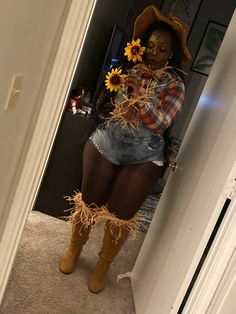 a woman is dressed up as a scarecrow with sunflowers