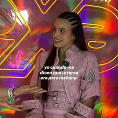 a woman standing in front of a neon sign with her hand out to another person