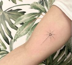 a woman's arm with a small star tattoo on the back of her left arm