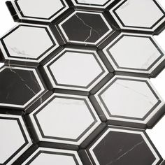 the black and white hexagonal tiles are arranged together