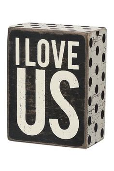 a black and white block with the word love us on it's front side