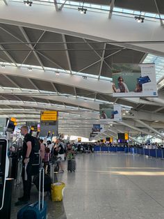 an airport with people waiting for their luggage