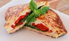 two grilled sandwiches with tomatoes, cheese and basil