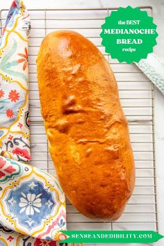 a loaf of bread sitting on top of a cooling rack next to a cloth and napkin