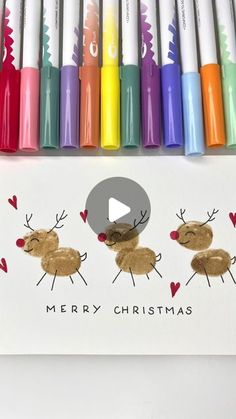 a christmas card with markers and crayons on it that have reindeers drawn on them