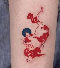 a woman's leg with a cat and dog tattoo on the side of her arm