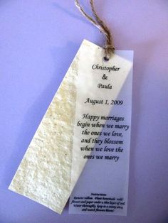 a paper tag hanging from a string on a purple wall with the words happy marriage written on it