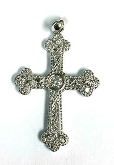 18kt White gold ladies diamond cross pendant. The cross measures 1.5" x 7/8". Center diamond is approximately 3mm, G color and SI1 clarity. Weight approximately 0.09ct. There are 18 smaller diamonds totalling approximately 0.32ctw. Total weight of the pendant is 3 grams.  655BHC8899 ID: 28657 Gemstone Diamond Ring, Diamond Cross Pendants, Diamond Cross, Ruby Diamond, Multi Stone Ring, Fine Jewellery Necklace, Multi Stone, Pearl Drop, The Cross