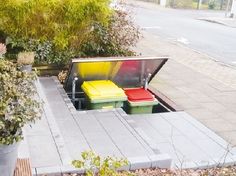 an outdoor bench with two colorful stools on it