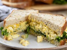 an egg salad sandwich cut in half on a plate