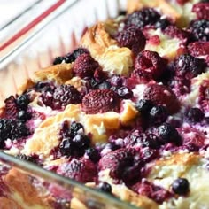 an easy breakfast croissant puff is in a glass dish on a red and white tablecloth