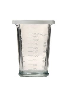 a measuring cup filled with liquid on a white background