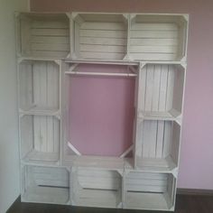 an empty white bookcase in the corner of a room