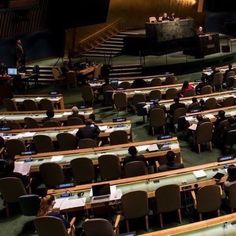 people sitting at desks in an auditorium