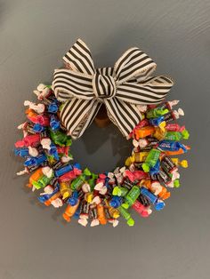 a wreath made out of candy is hanging on the wall