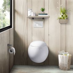 there is a white toilet in the corner of this bathroom with wood paneling on the walls