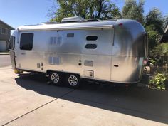 a silver trailer parked in front of a house