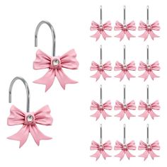 several pink bows are hanging on hooks