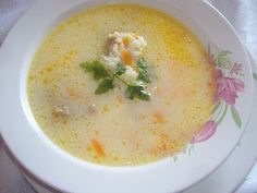 a white bowl filled with soup on top of a table