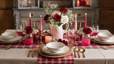 the table is set with red and white dishes