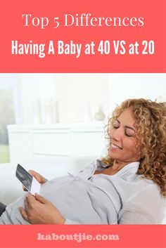 a woman laying on top of a couch holding a remote control