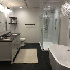 a bathroom with a tub, toilet and sink in it's center area is shown