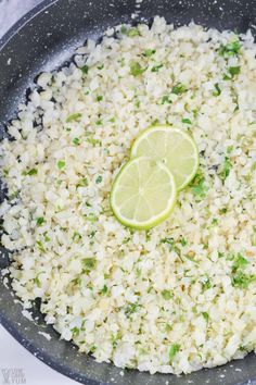 a pan filled with rice and lime slices