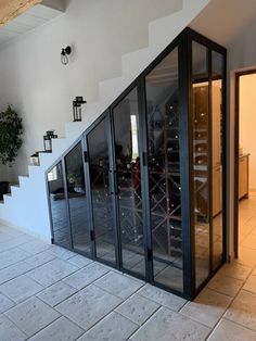 a room that has some glass doors on the wall and stairs in front of it