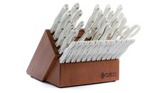 a wooden holder with white utensils in it