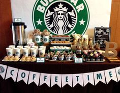 a table topped with lots of coffee cups and desserts next to a starbucks sign