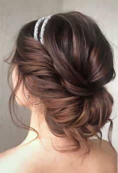 a woman with her hair in a low bun