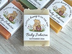 four soap bars with winnie the pooh on them sitting next to each other in front of a wooden table