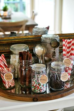 jars filled with candy canes and candies on a tray