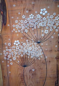 some white flowers are on a wooden board