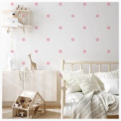 a child's bedroom with pink wall decals on the walls and furniture in the room