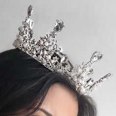 a close up of a woman wearing a tiara