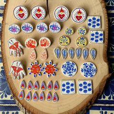 an assortment of decorative ceramic items displayed on a wooden board with blue and white designs