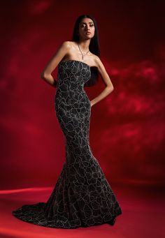 A black tube gown dazzles with striking floral embroidery and a flowing trail, creating a show-stopping look that combines sophistication with bold style. Tube Gown, Gown For Women, Gown Pattern, Black Tube, Embellished Gown, Beaded Neckline, Ladies Gown, Contemporary Fashion, Bold Fashion