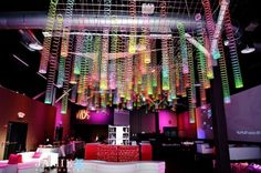 a room filled with lots of colorful lights and decorations hanging from the ceiling above it