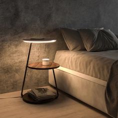 a table with a cup on it next to a bed