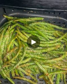 green beans are being cooked in an air fryer